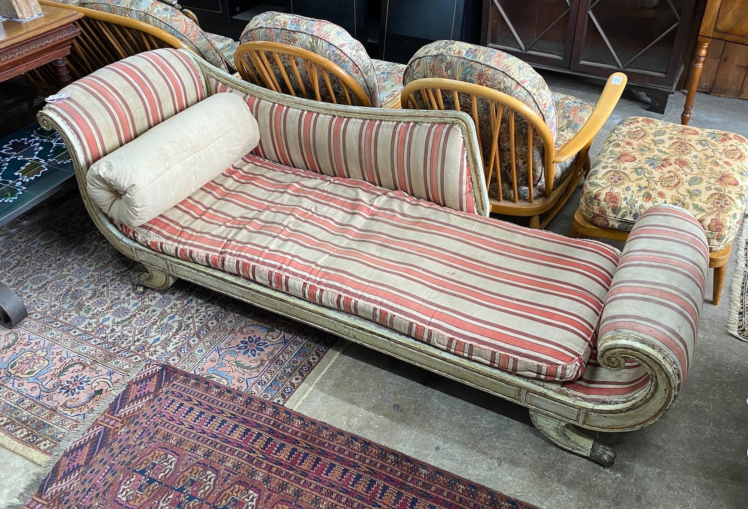 A Regency painted parcel gilt scroll end chaise longue, length 196cm, width 65cm, height 70cm